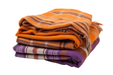 Folded blankets in orange and purple hues are stacked