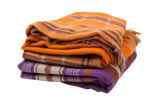 Folded blankets in orange and purple hues are stacked