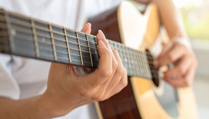 Obraz premium Close up of Hands Playing Acoustic Guitar Practicing Music or Composing Song Performing Leisure Activity.