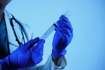 doctor's hand holds a syringe and a vaccine bottle at the hospital. Health and medical concepts. vaccination flu shot paramedics in hospital concept.selective focus hand doctor syringe injection.