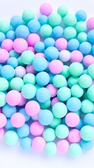 Obraz premium A close-up view presents a vibrant collection of small, spherical, pastel-colored objects arranged closely together on a white background
