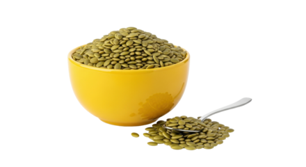 Isolated yellow bowl overflowing with pepitas and small pile with spoon, nutritional snack