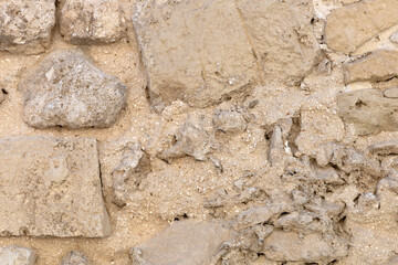 Vintage beige brick wall background with stone texture