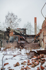 Collapsed brick walls and rusted metal reveal an abandoned industrial ruin