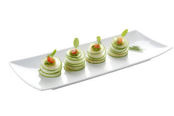 Cucumber appetizers with pesto and tomato on white plate