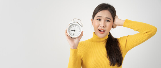 Shocked Asia young woman looking at clock alarm, lady is late appointment or work or class study,...