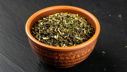A close-up shot features a rustic, earthenware bowl overflowing with dried green herbs and plant matter against a dark surface
