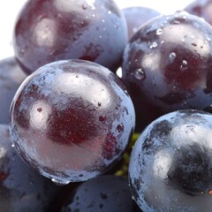 A close-up shot features ripe, dark-purple spheres with glistening water droplets on their surfaces, contrasting with a white background