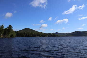 A panoramic view of a lake nestled in the Adirondacks.