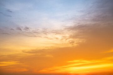 Obraz premium Beautiful , luxury soft gradient orange gold clouds and sunlight on the blue sky perfect for the background, take in evening,Twilight, Large size, high definition landscape photo
