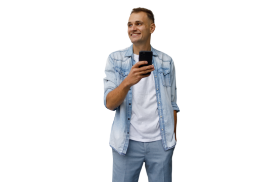 Casual man smiling, holding smartphone, looking away in thought, using mobile device, communication concept