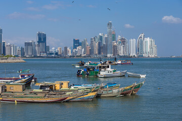 The waterfront promenade Cinta Costera with a view on the skyscrapers of Panama City and the marina with old fish boats - Panama