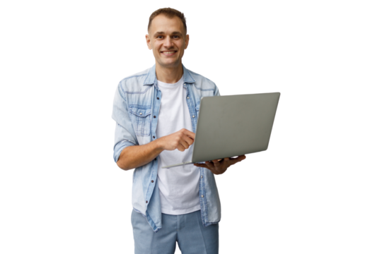 Smiling man holding and typing on laptop, presenting online content on transparent background