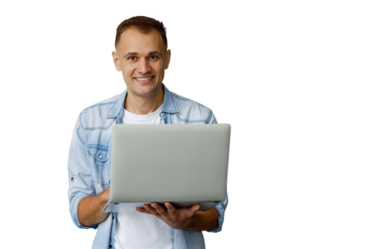 Smiling man wearing a denim shirt, holding an open laptop, working remotely with transparent background