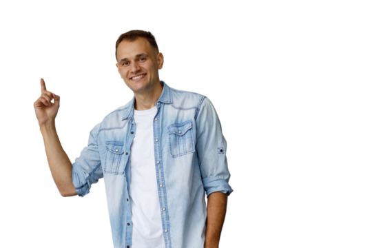 Man in denim shirt pointing up, having an idea, suggesting solution or product, smiling cheerfully