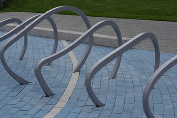 Modern Curved Bike Racks on Blue Urban Pavement: Abstract Design