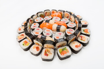 Sushi, maki and rolls - japanese food restaurant delivery, platter set isolated at white background, placed in circle