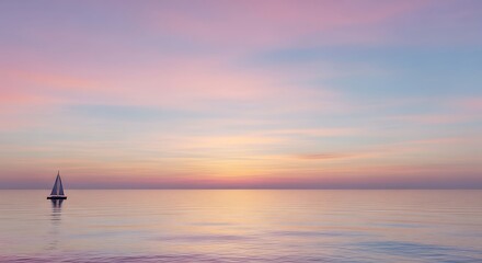 Sailboat on serene sea at sunset with pastel colored sky