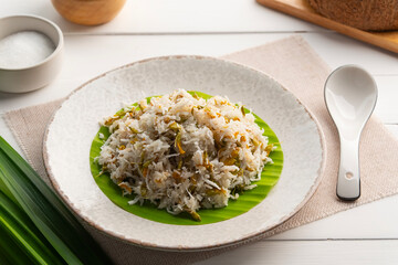 Kanom khao niew Dok Sano,Thai steamed sticky rice with Sesbania flower and shredded young coconut in a plate.Thai dessert.