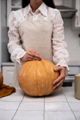 Embrace the joy of Autumn with Pumpkin Carving in a Cozy Kitchen Setting, full of warmth