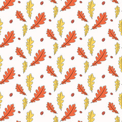 Seamless pattern of orange and yellow oak leaves and acorns isolated on white background