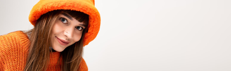 Warm and stylish young woman brings autumn vibes with joyful expression