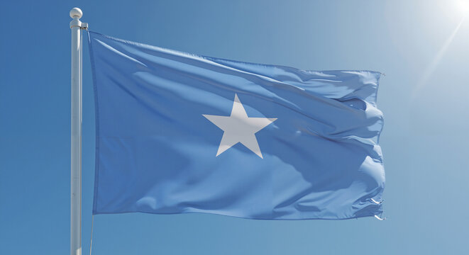 Somali flag waving under clear blue sky  
