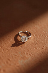wedding ring with diamond on a brown  background