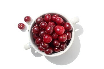 There is a pile of ripe juicy cherries on the plate.	