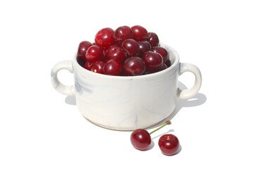 There is a pile of ripe juicy cherries on the plate.	