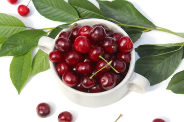 There is a pile of ripe juicy cherries on the plate.	