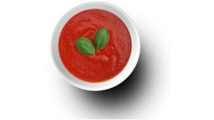Fresh tomato soup with basil leaves in white bowl