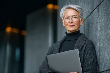 Elderly businesswoman wearing glasses using a laptop outdoors embodying strength and independence