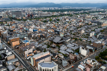Aerial view of Kyoto, Japan, featuring a large temple complex, traditional and modern architecture,...