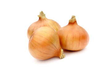 Fototapeta premium Several yellow onions lie on a white background.