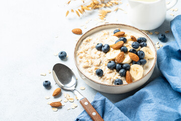 Oatmeal porridge with bananas, nuts and blueberries.