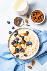 Oatmeal porridge with milk, bananas and blueberries.