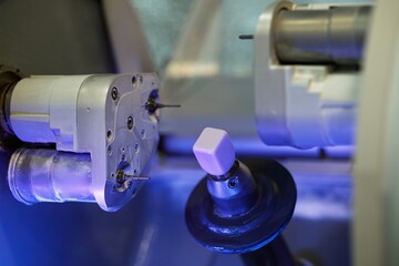 Dental milling machine and ceramic cube for crowns, with blue backlight