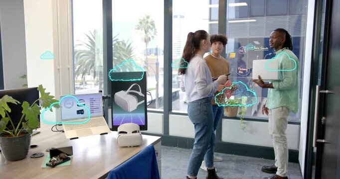 Product designer tapping tablet while cloud icons forming around teammates showing VR team review