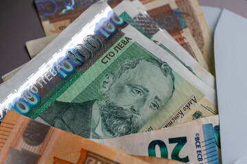 Lev and 20 Euro banknotes emerge from an envelope, illustrating Bulgaria's currency transition to...