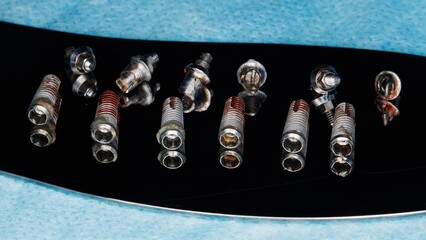removed dental implants and abutments of the entire upper jaw on the mirror © Dental Pro Content