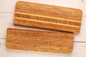 Kitchen broken cutting board on wooden table, close-up, top view.