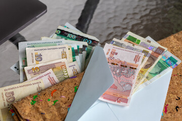 Bulgarian Lev banknotes, including 5, 10, 50, and 100 denominations, are displayed. This image...