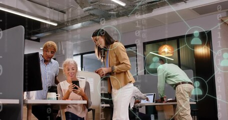 Team reviewing tech data, woman scrolling phone sparking code turning into network icons - Powered by Adobe