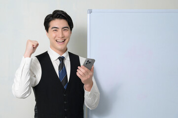 スマホを持って喜ぶ日本人男性