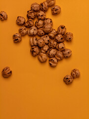 Roasted chickpeas flat lay on a vibrant orange background