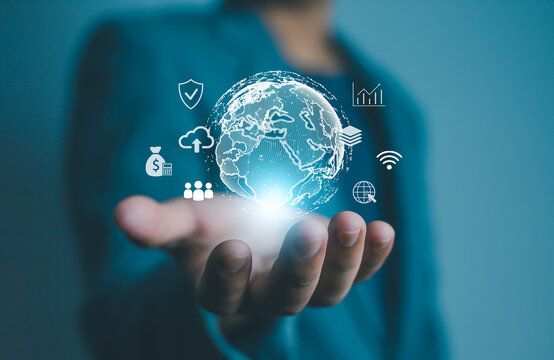 Businessman holding digital globe with technology and communication icons, symbolizing global network, data innovation, cloud computing, and digital transformation in modern business strategy.