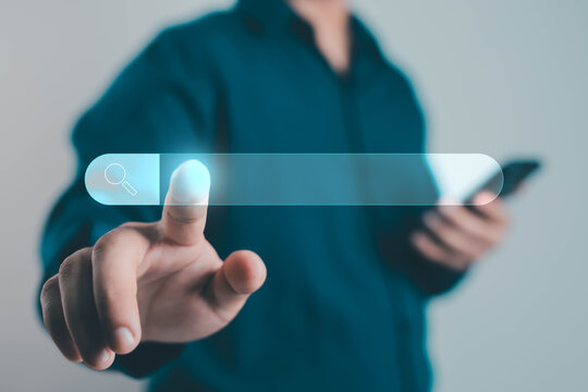 Businessman touching a virtual search bar icon on a transparent interface concept, symbolizing internet browsing, online search, SEO technology, and digital innovation in modern communication.