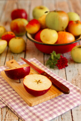 Apples in vintage tin bowl and on rustic wooden table