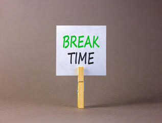 Break time symbol. Concept word Break time on beautiful white paper. Beautiful wooden clothespin. Beautiful grey background. Business break time concept. Copy space.